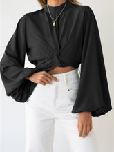 Top con mangas abullonadas y color liso con detalle de lazo